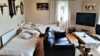 Two  beds placed behind the sofa in the living room