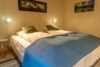 Double bed in bedroom in Aurora guest house