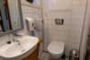 Vindow in bathroom with wasbasin and toilet