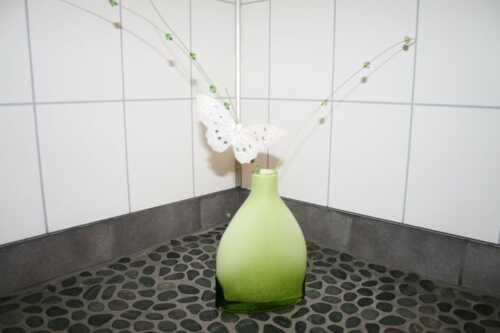 Green vase with butterfly in the bath room 