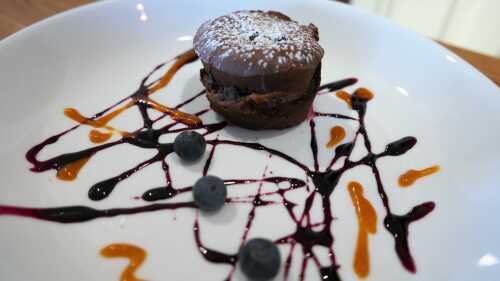 Chocolate Fondant on plate with yellow and blue dekoration and blueberries